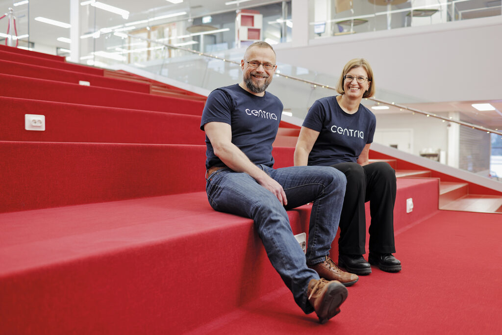 Centria's Director of Research and Development Marko Forsell and Director of Education Jennie Elfving sitting on the benches in the school library.