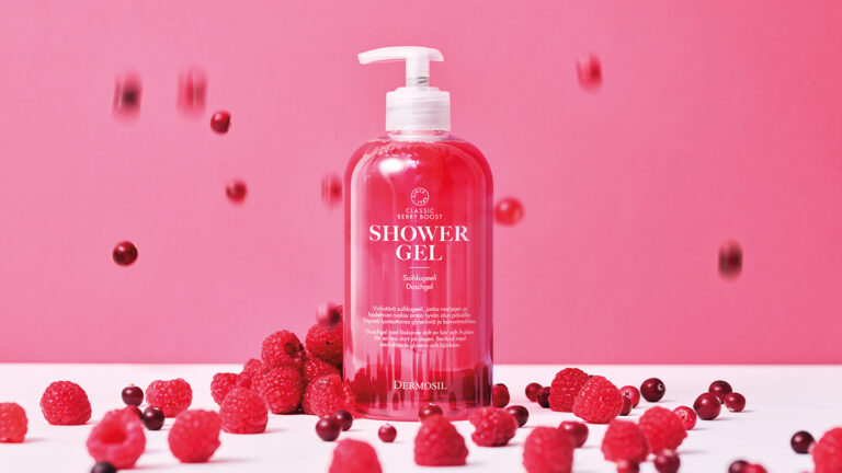 Dermosil shower gel. Berries surround the bottle and more of them fall from above.