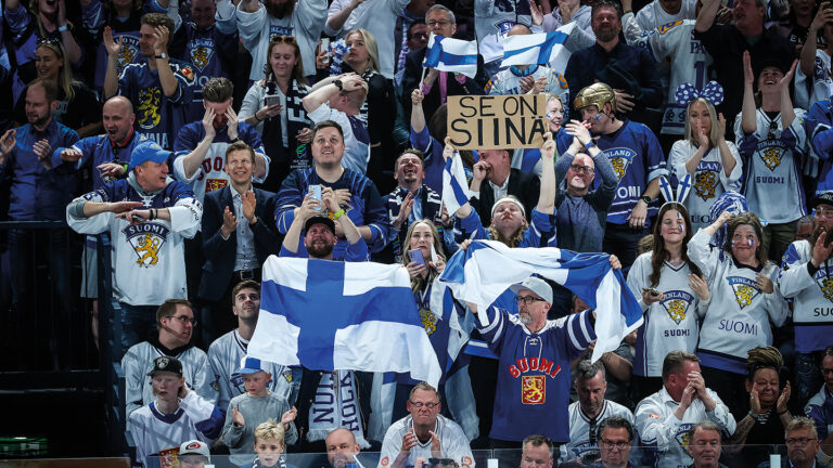 Finnish hockey fans celebrating in the stands during the final game of the 2022 World Championships.