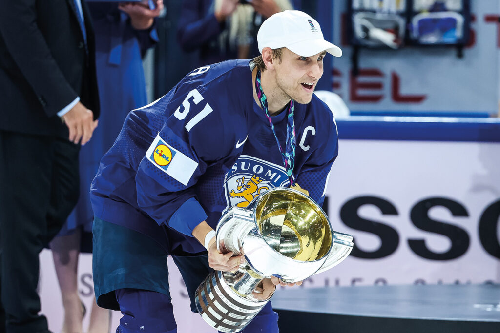 The Finnish men's national ice hockey team's captain Valtteri Filppula about to raise the World Championships 2022 trophy in the air to celebrate.