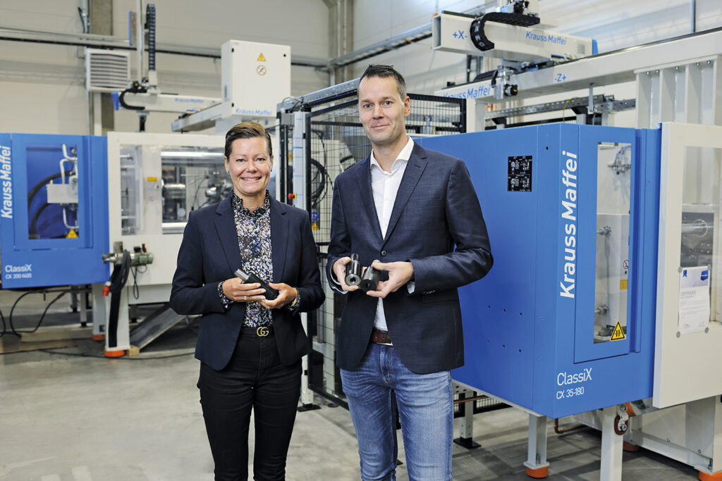 Mekrapid Products’ Managing Director Fredrika Furu and Technical Director Alfred Kjellman at a factory with machinery in the background.