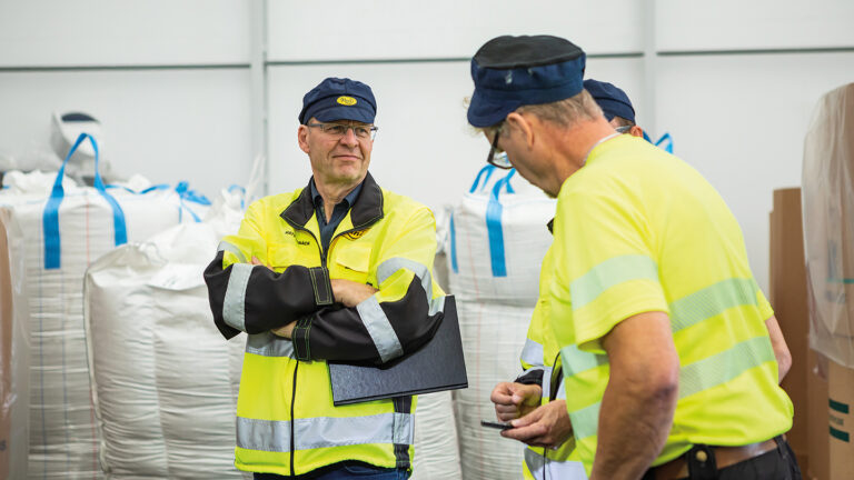 Rani Plast’s Sustainability and Development Director Mats Albäck with two other employees. All are wearing safety equipment.