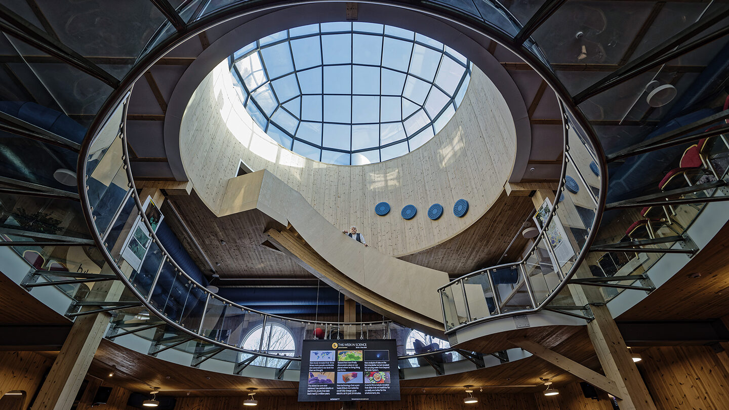 Wasa Innovation Center’s lobby, founder Sture Udd is standing in the middle of its staircase. There is a big glass dome on the roof.