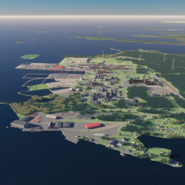The Kokkola Industrial Park pictured from high above by the sea. There are multiple buildings and a forest.