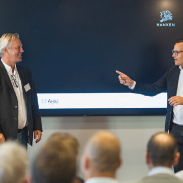 Kai Kamila and Marc Hinnenberg giving a presentation. There is a screen behind them with a Hanken logo on it.
