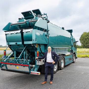 Niclas Pada pictured in front of a refuse collection vehicle.