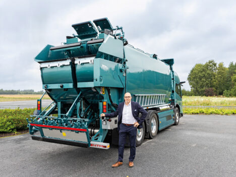 Niclas Pada pictured in front of a refuse collection vehicle.
